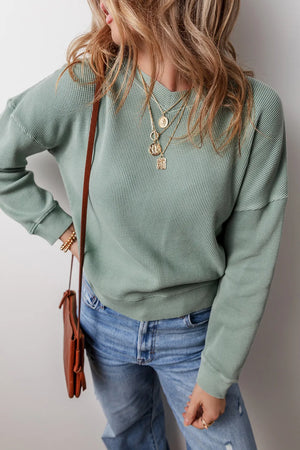 Sage waffle knit crewneck sweater with crew neckline and long sleeves.