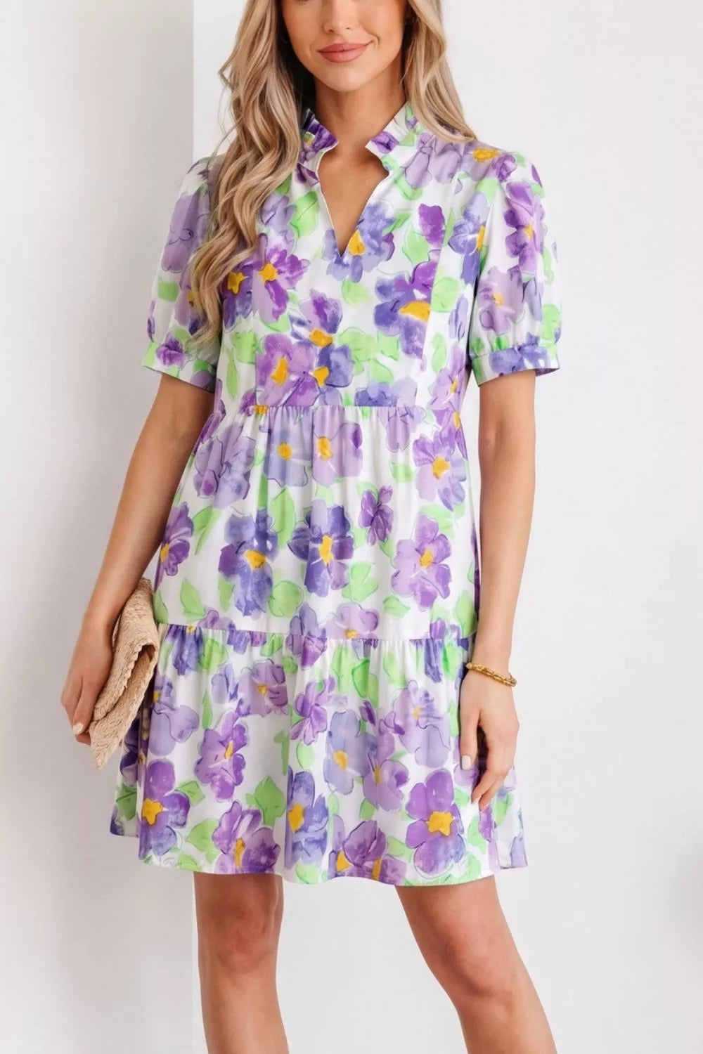 Vibrant floral tiered ruffle mini dress with short sleeves and a mock neck.