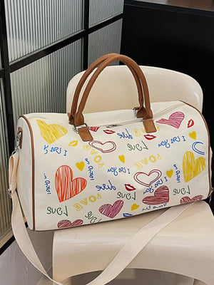 Vibrant canvas duffel bag with colorful heart and love print, brown trim, and adjustable strap.