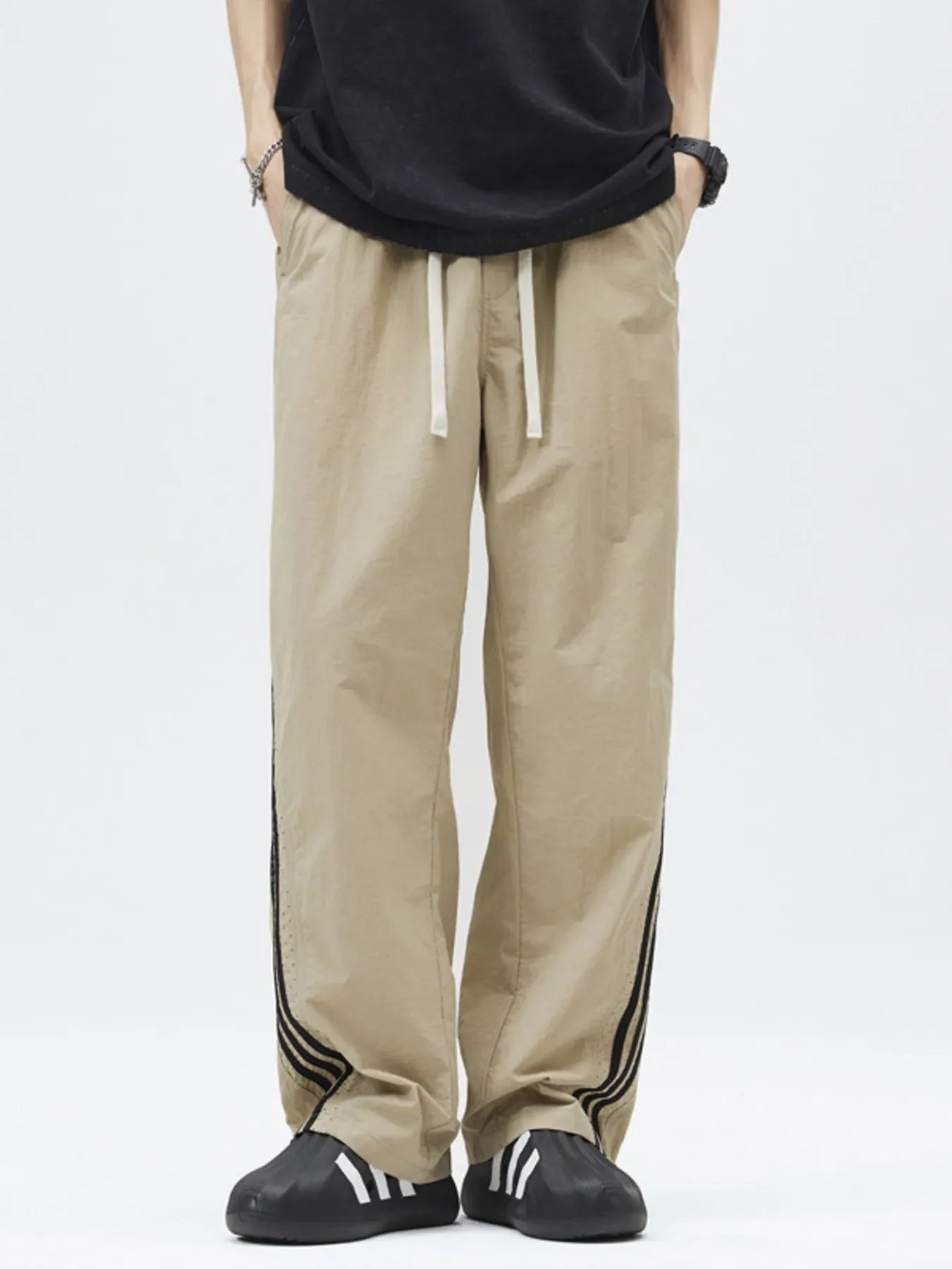 Khaki casual drawstring pants with side stripe detail and loose fit