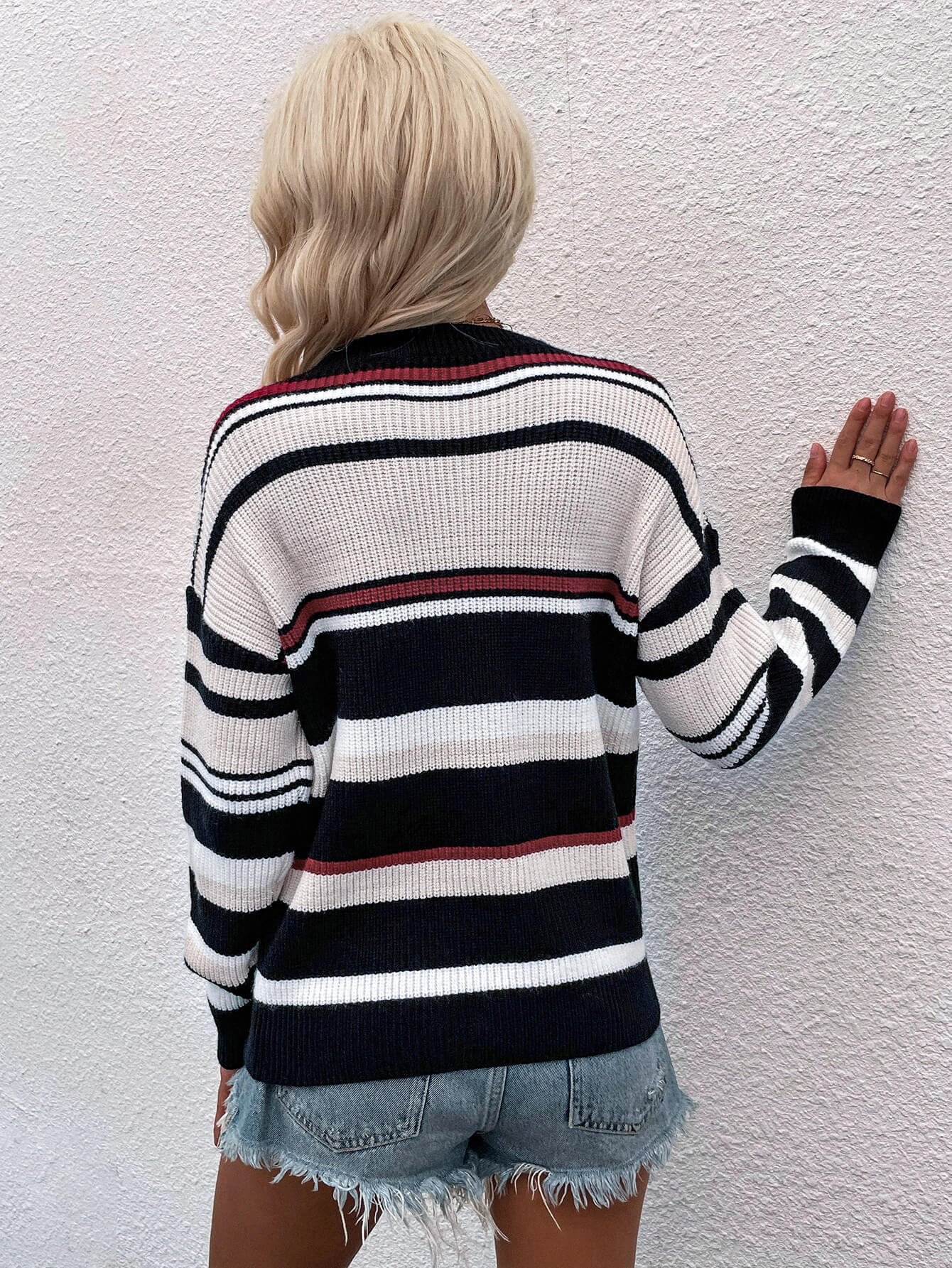 Pastel stripe crewneck knit sweater with black, white, beige, and red stripes.