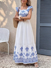 Printed square neck maxi dress with royal blue and white pattern, ruffle sleeves, tiered skirt.