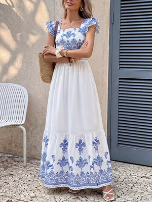 Printed square neck maxi dress with royal blue and white pattern, ruffle sleeves, tiered skirt.