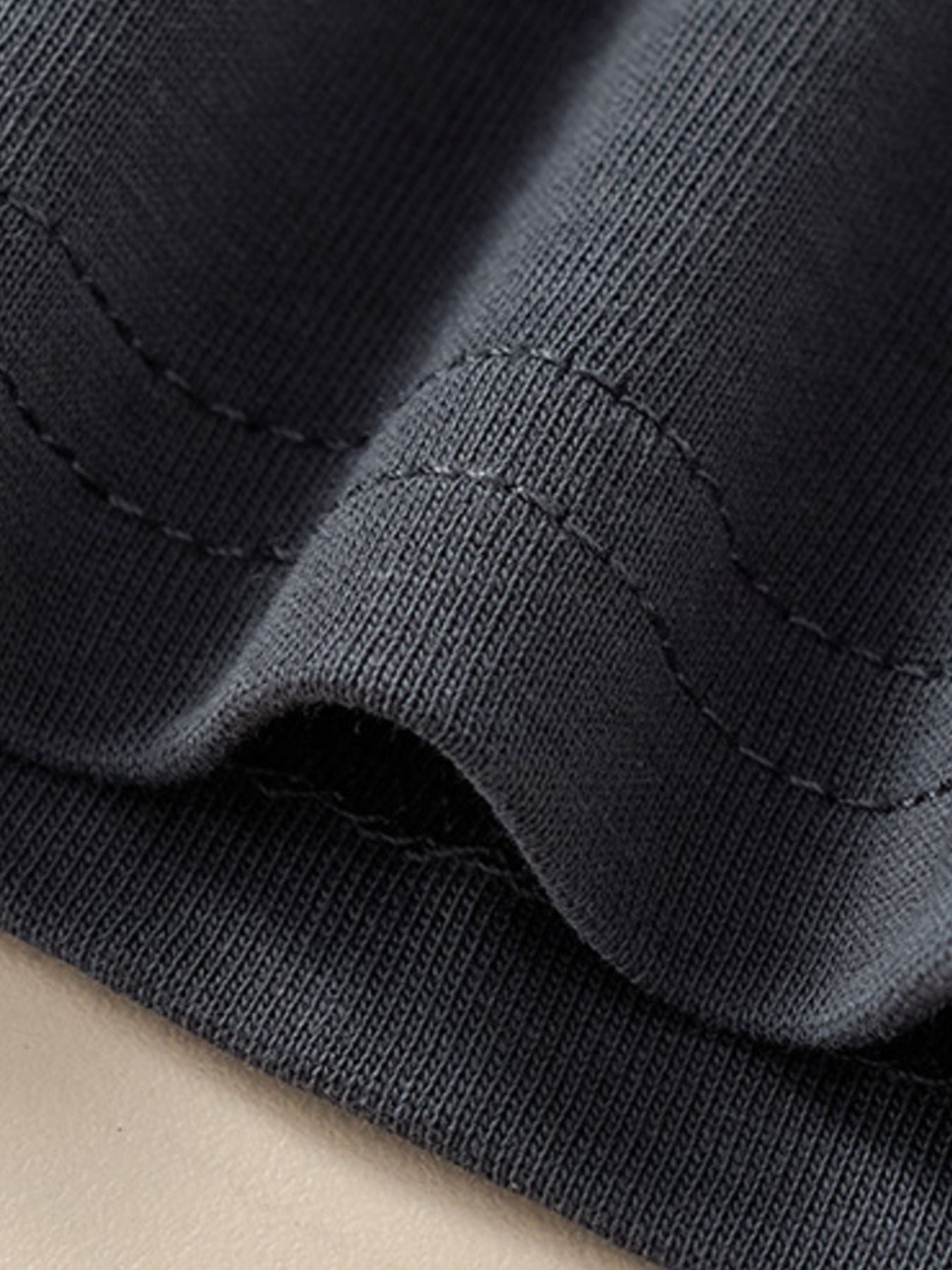Kids dark gray cotton t-shirt detail showing ribbed texture and stitching.