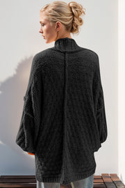 Black textured bouclé cocoon cardigan with balloon sleeves and mock neck