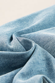 High-waisted palazzo flare denim jeans in medium wash with a textured fabric detail.