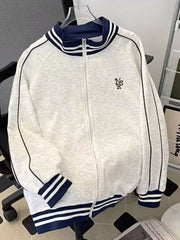 Gray zip-up sweatshirt with navy blue striped collar and cuffs, featuring side stripe detail.