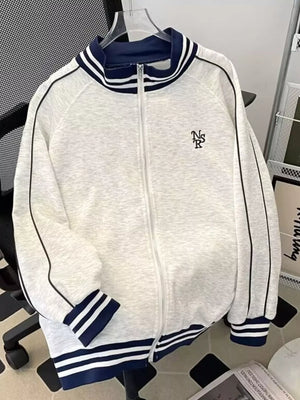 Gray zip-up sweatshirt with navy blue striped collar and cuffs, featuring side stripe detail.