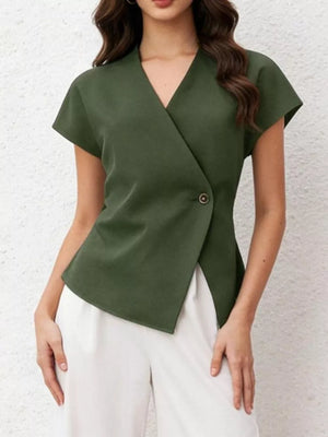 Green asymmetrical wrap shirt with cap sleeves and a single button detail.