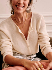 Cream cashmere button cardigan with plunging neckline and ribbed texture.