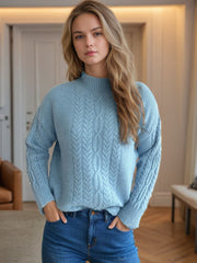 Light blue acrylic cable knit mock neck sweater with textured details.