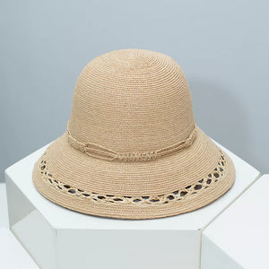 Woven straw bucket hat in Style B with twisted band and openwork brim detail.