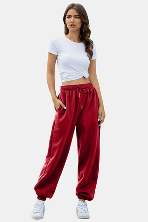 Slouchy gathered-cuff sweatpants in Deep Red with drawstring waist and pockets.