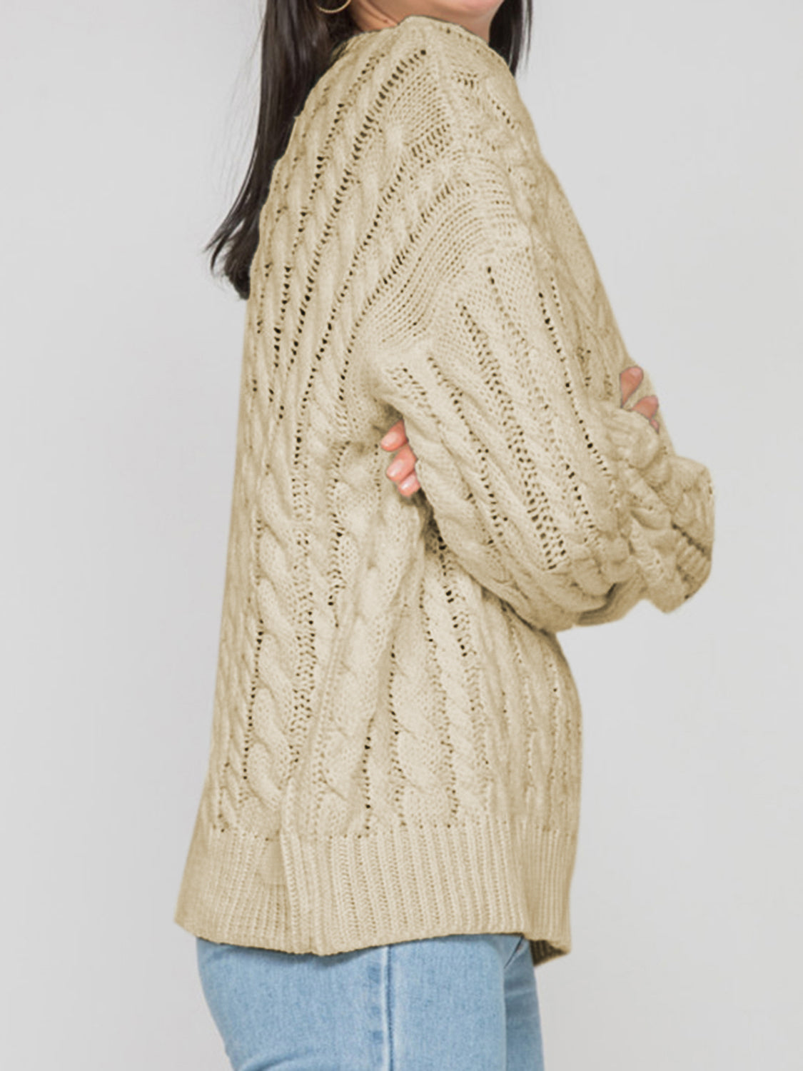 Sand cable knit openwork sweater with detailed knit pattern and ribbed hem.