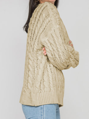 Sand cable knit openwork sweater with detailed knit pattern and ribbed hem.