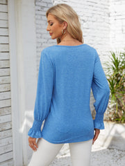 Sky blue blouson sleeve top with smocked cuffs and lace trim detail.