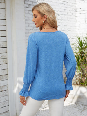 Sky blue blouson sleeve top with smocked cuffs and lace trim detail.