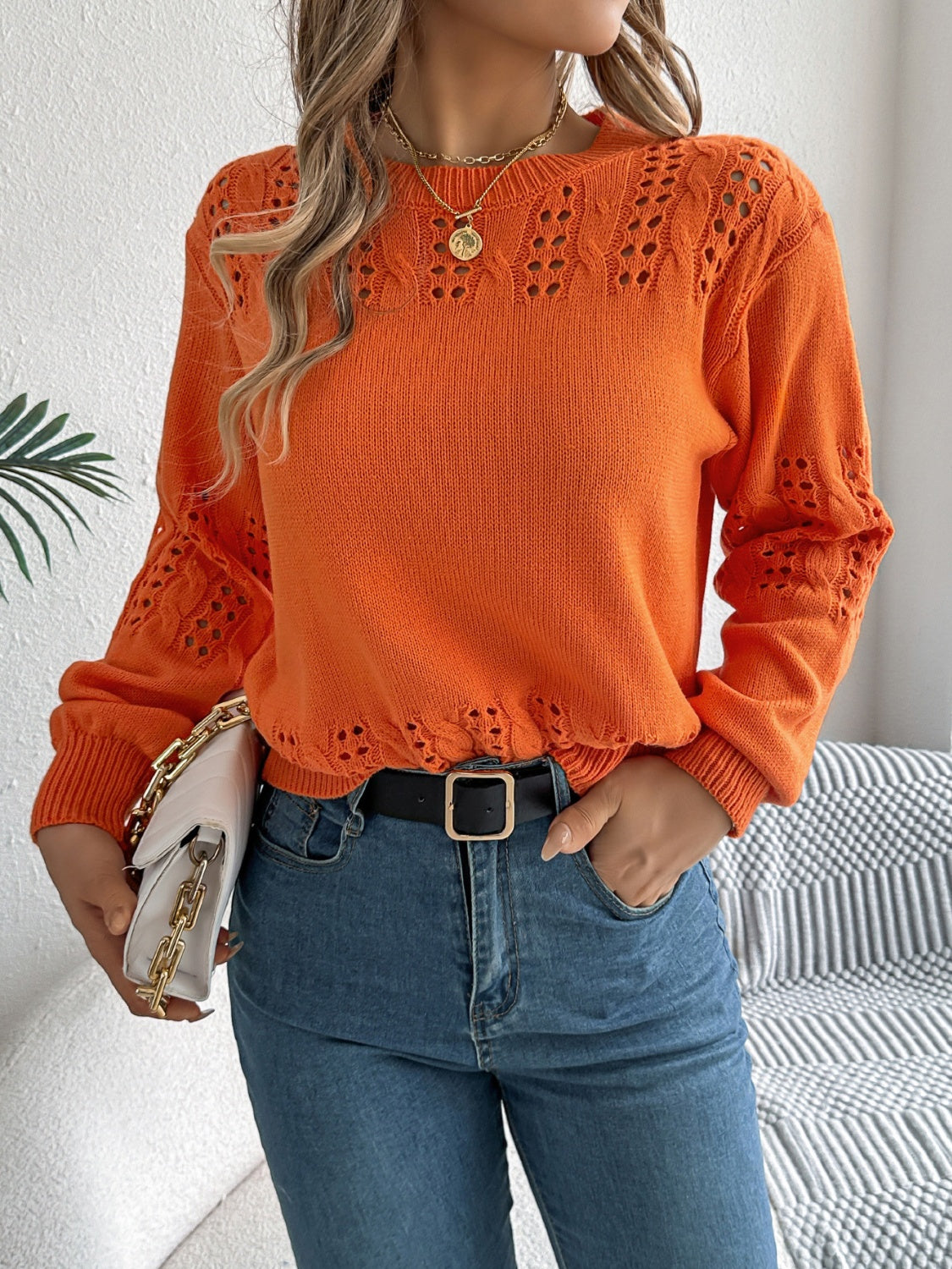 Pumpkin openwork knit sweater with crew neck and long sleeves, featuring intricate eyelet details on the yoke and cuffs.