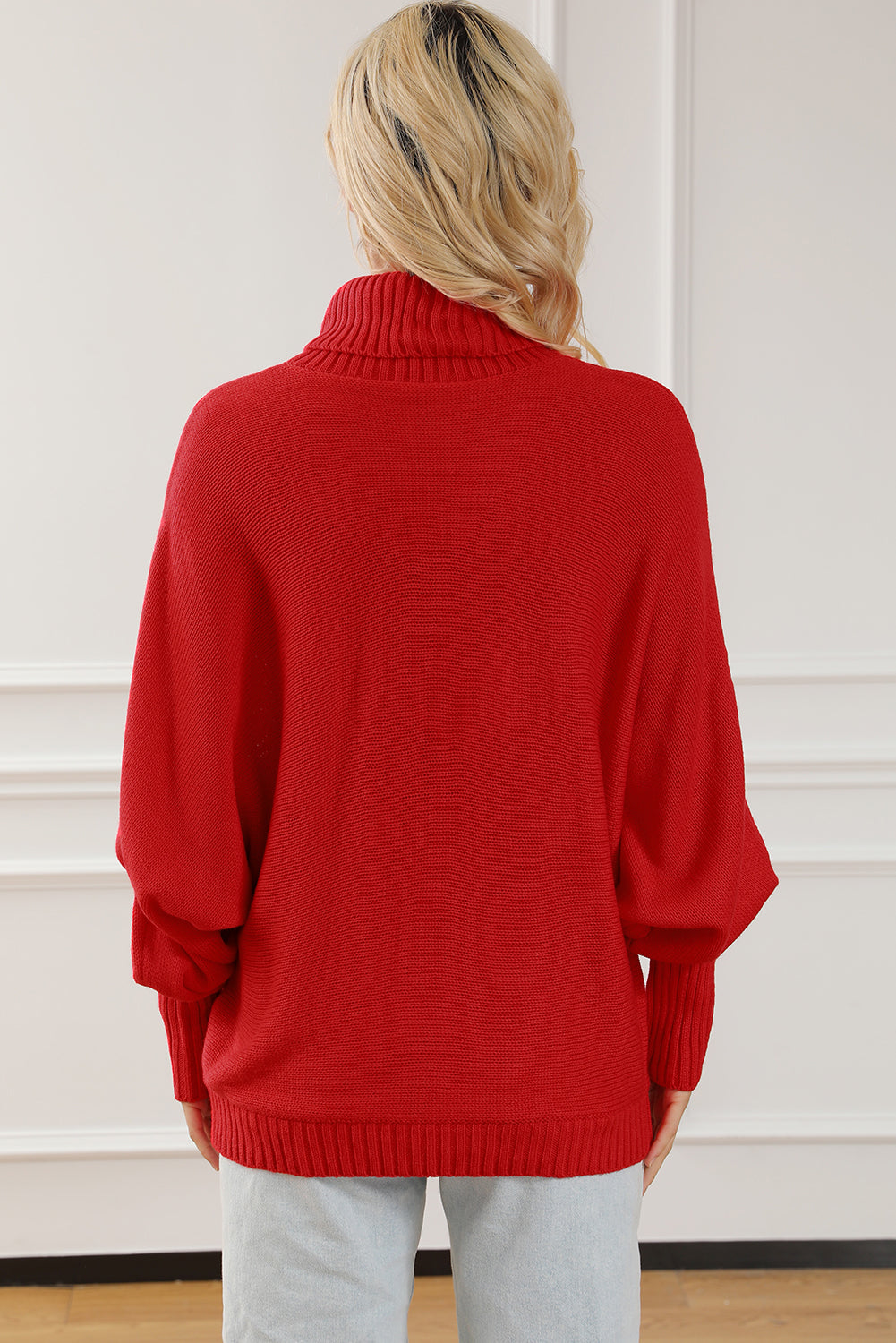 Red acrylic turtleneck sweater with dolman sleeves and ribbed cuffs and hem.