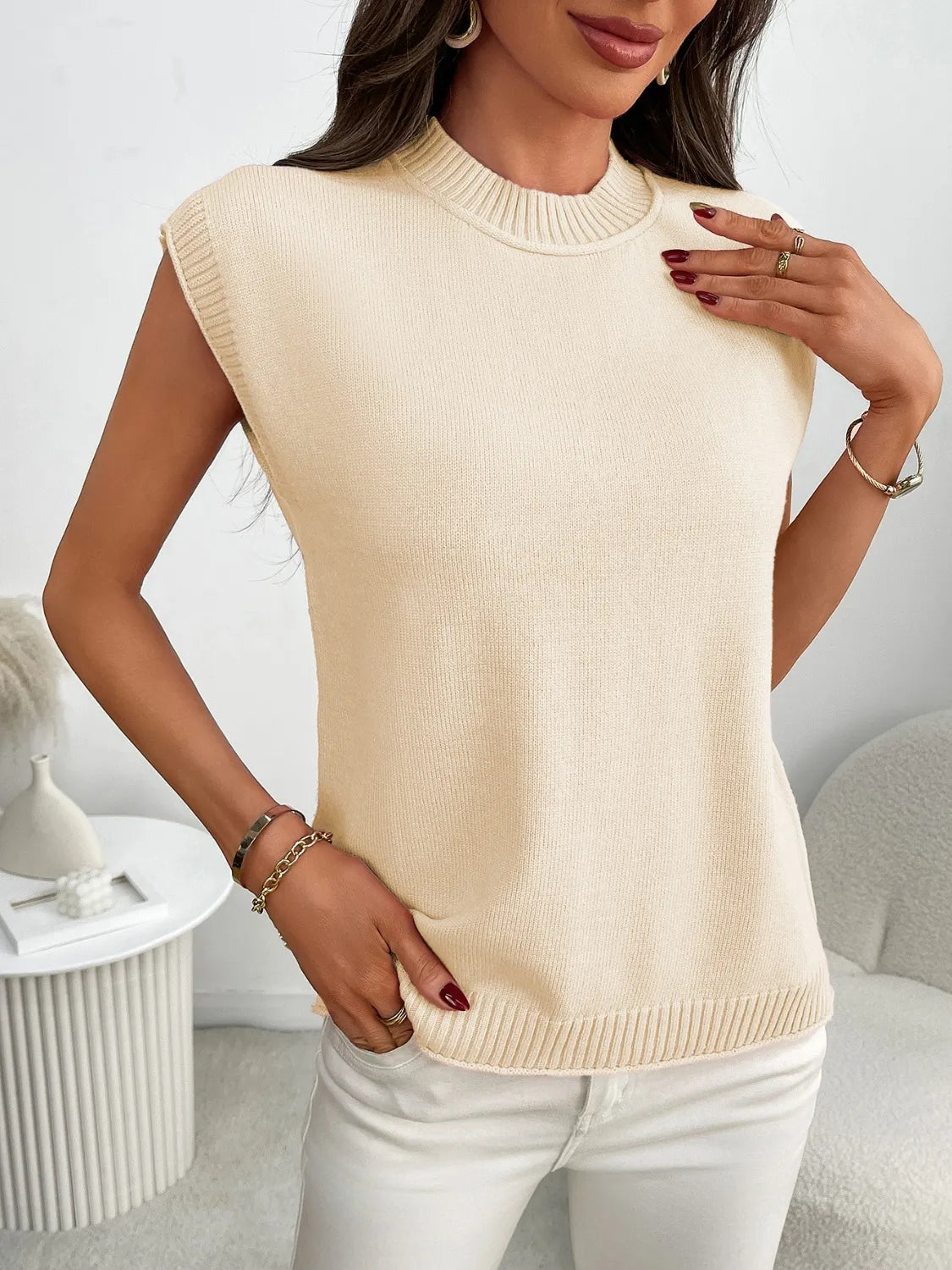 Cream ribbed knit sleeveless mock neck top with a relaxed fit.