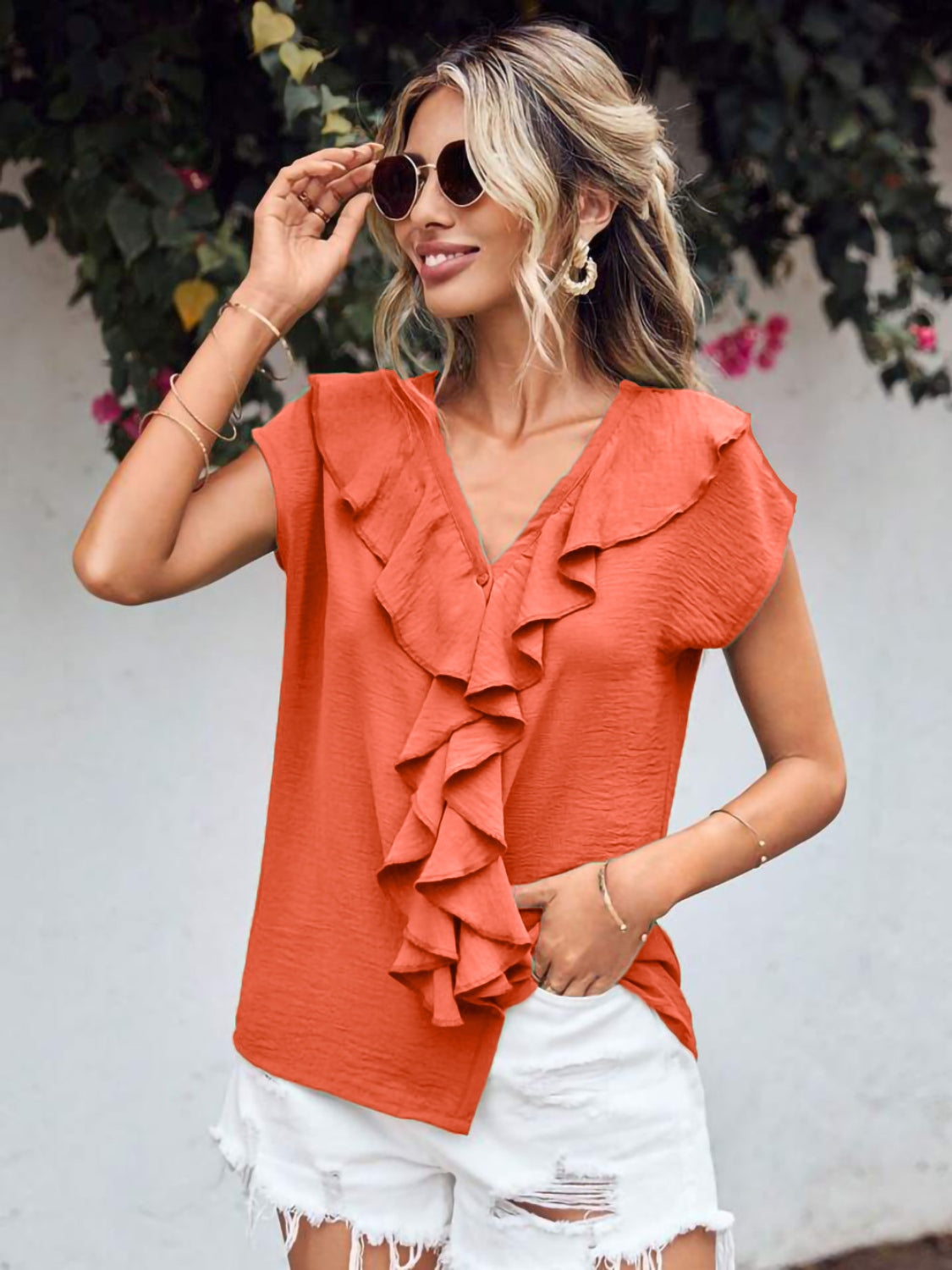 Orange-red flutter V blouse with ruffled front and short sleeves.
