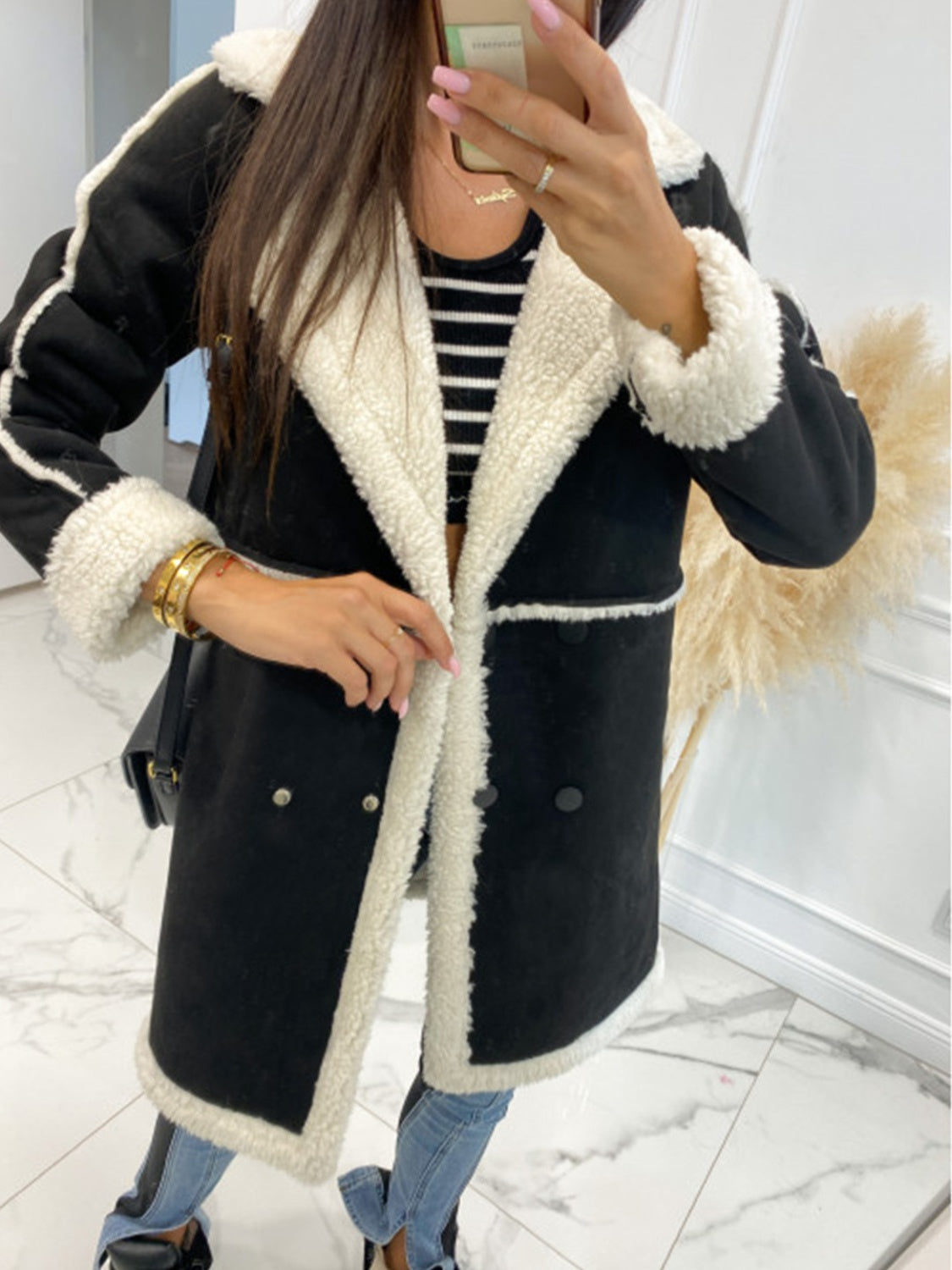 Black suede effect overcoat with shearling trim and collar, double-breasted front.