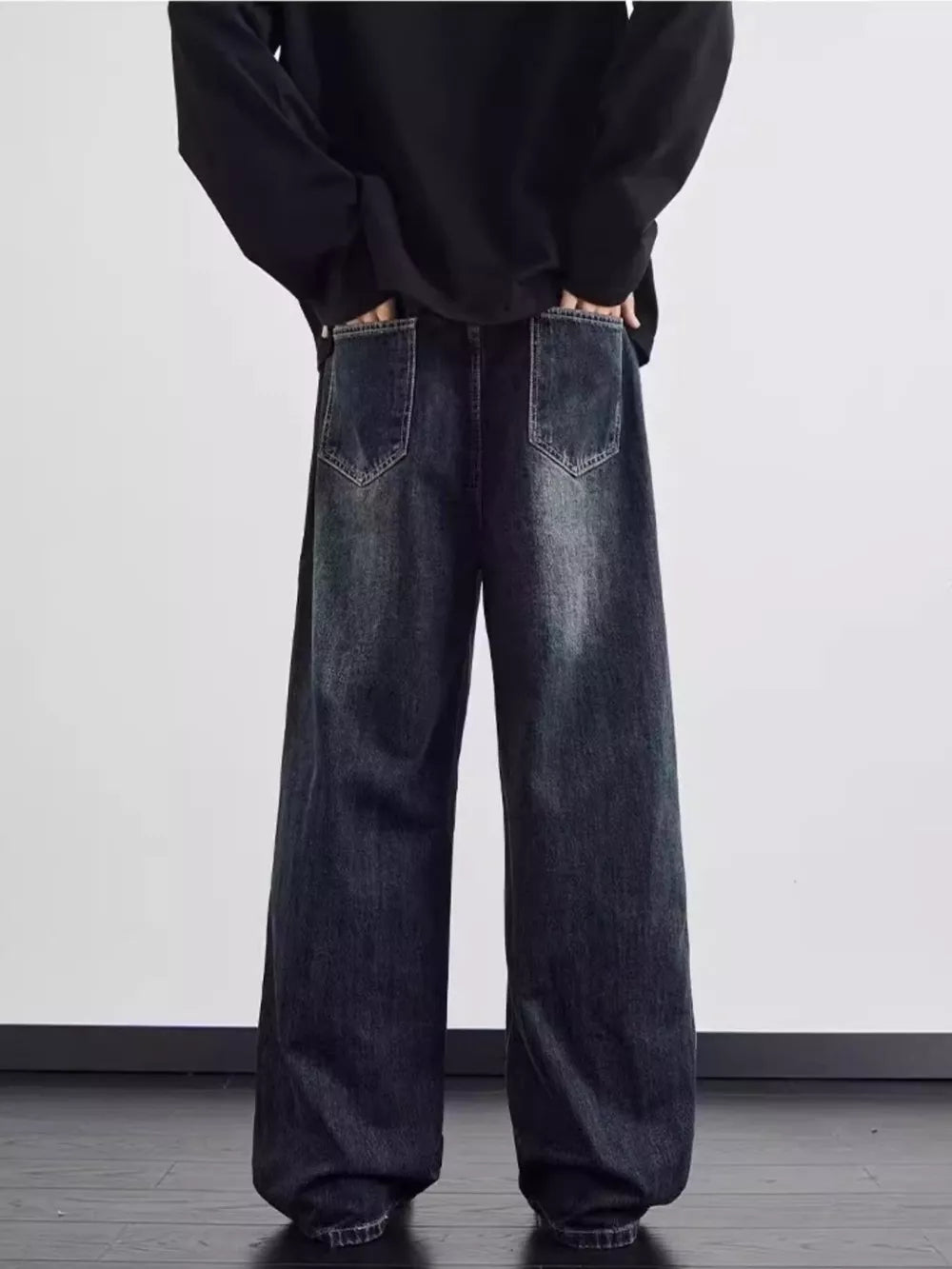 Distressed dark wash wide leg men's jeans with a relaxed fit.