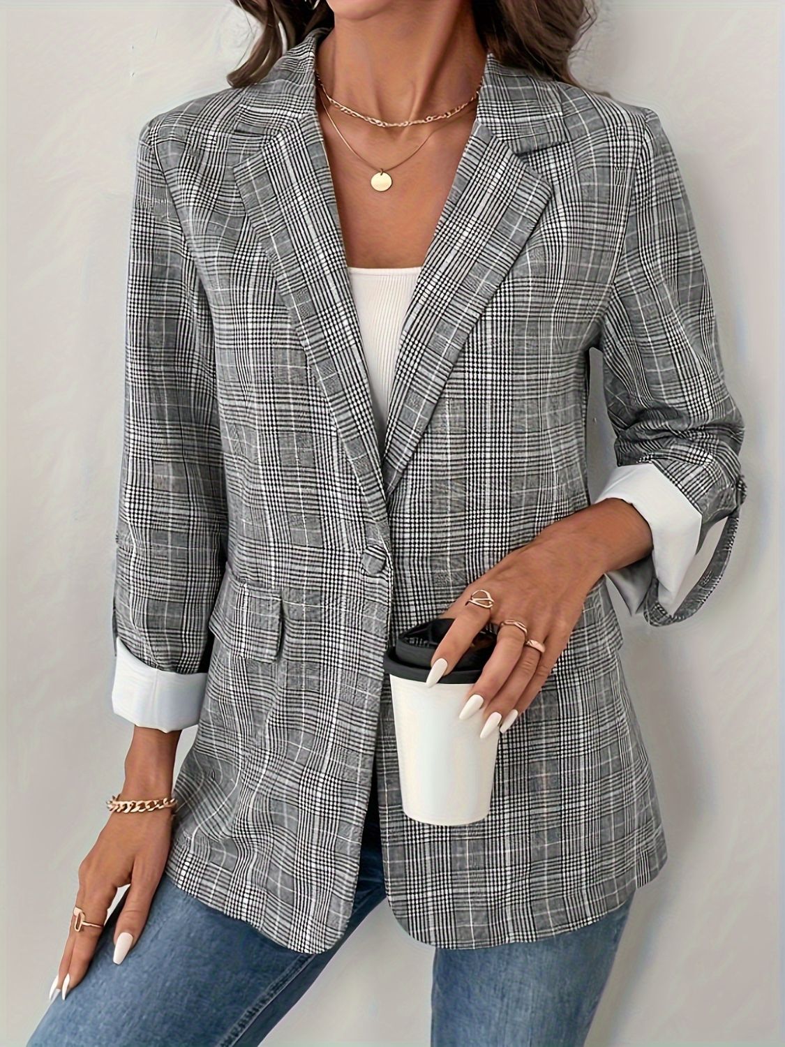 Checked cuff plaid blazer in light gray with buttoned front and rolled sleeves.