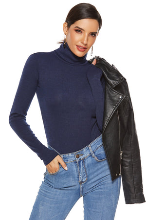 Dark blue ribbed turtleneck bodysuit with long sleeves, styled with jeans and a leather jacket.