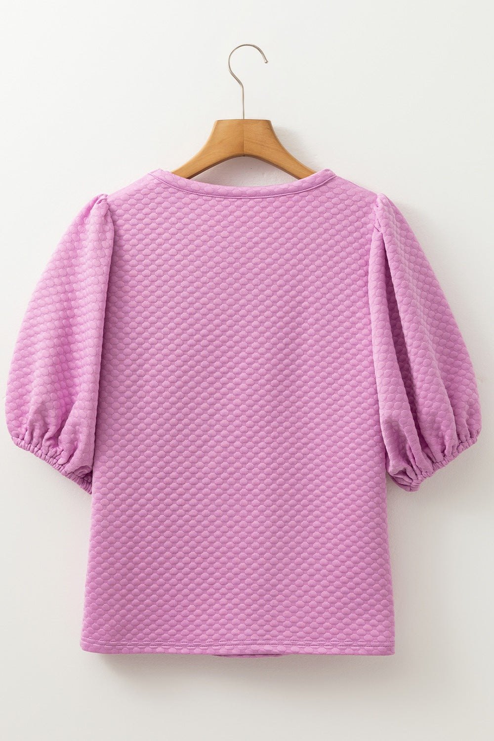 Textured quilted puff sleeve blouse in pink purple with a round neckline.