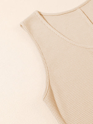 Camel waffle knit button-down romper detail with V-neck and cap sleeves.