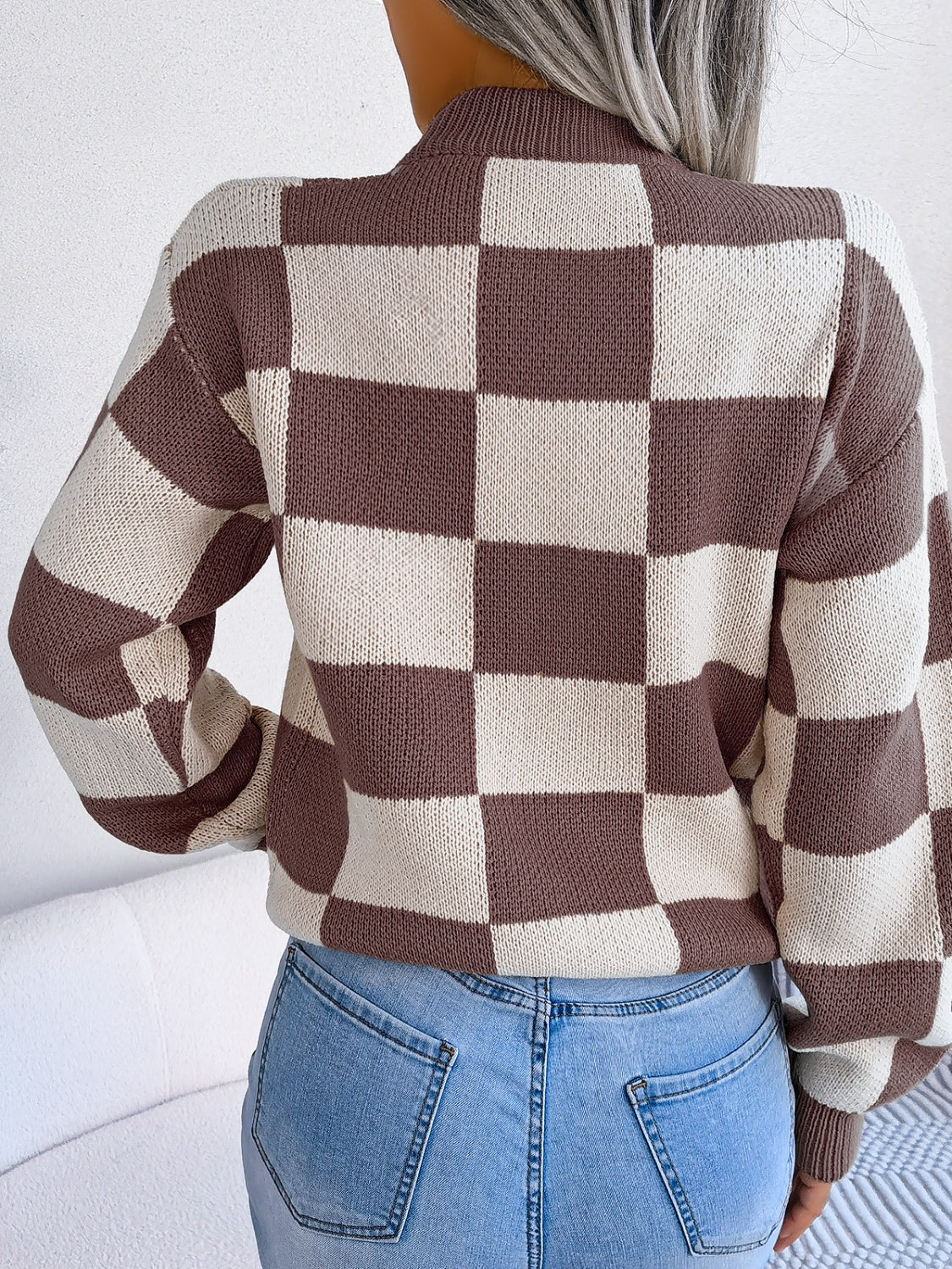 Checkerboard knit mock neck pullover in camel and cream acrylic with long sleeves.