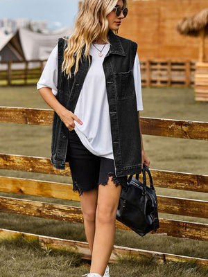 Sleeveless dark gray denim utility vest with button front and chest pockets.