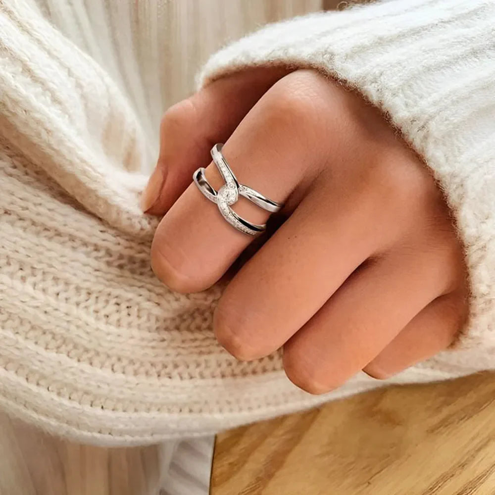 Silver intertwined pavé band ring with sparkling details