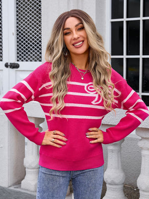 Watermelon pink striped knit pullover sweater with white stripes and a bow detail.