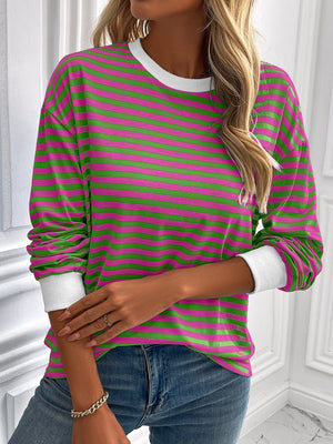 Crewneck sweatshirt with horizontal pink and green stripes and white cuffs.