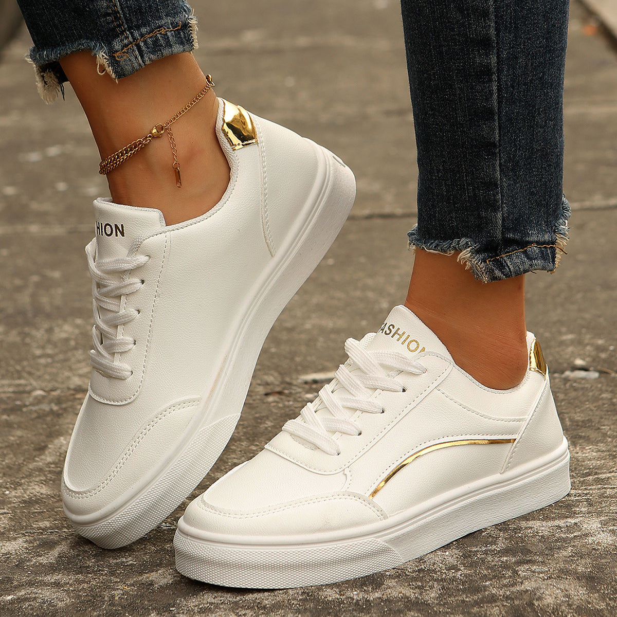 White lace-up casual sneakers with gold accents and "Fashion" detail.