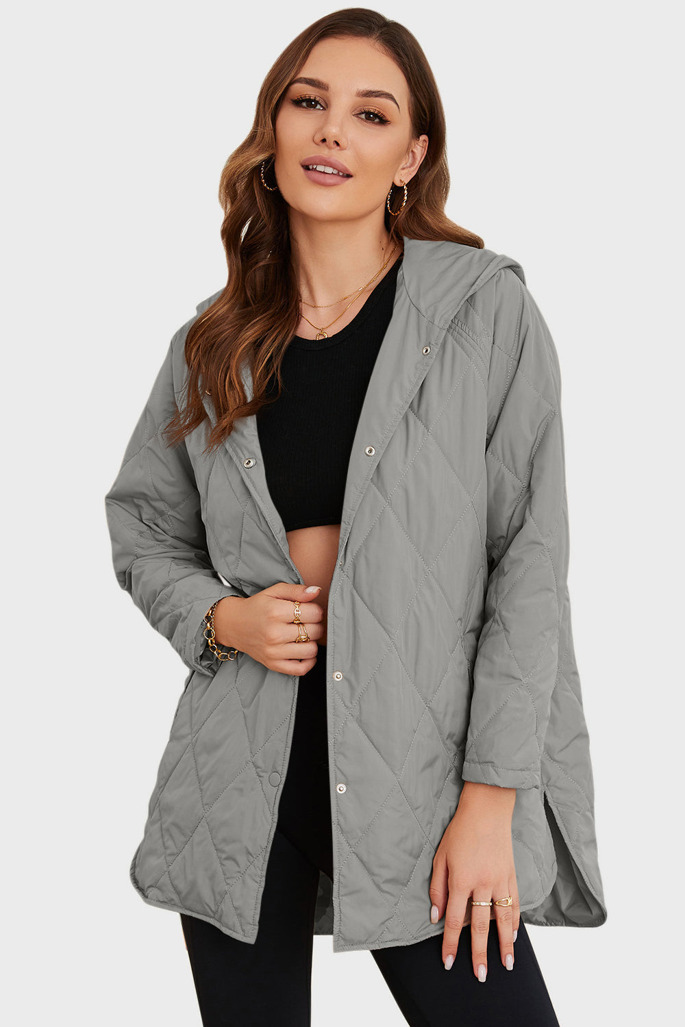 Light gray quilted hooded parka with snap front closure and side slits.