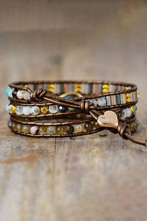 Bohemian wrap bracelet with agate beads, leather cord, and gold heart charm.