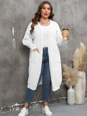 White oversized knit duster cardigan with patch pockets and ribbed cuffs.