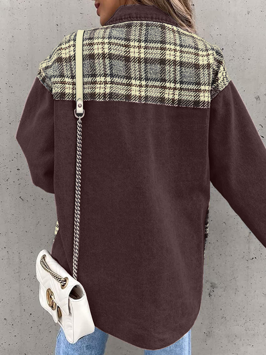 Brown denim jacket with plaid paneling on shoulders, buttoned front, casual styling.