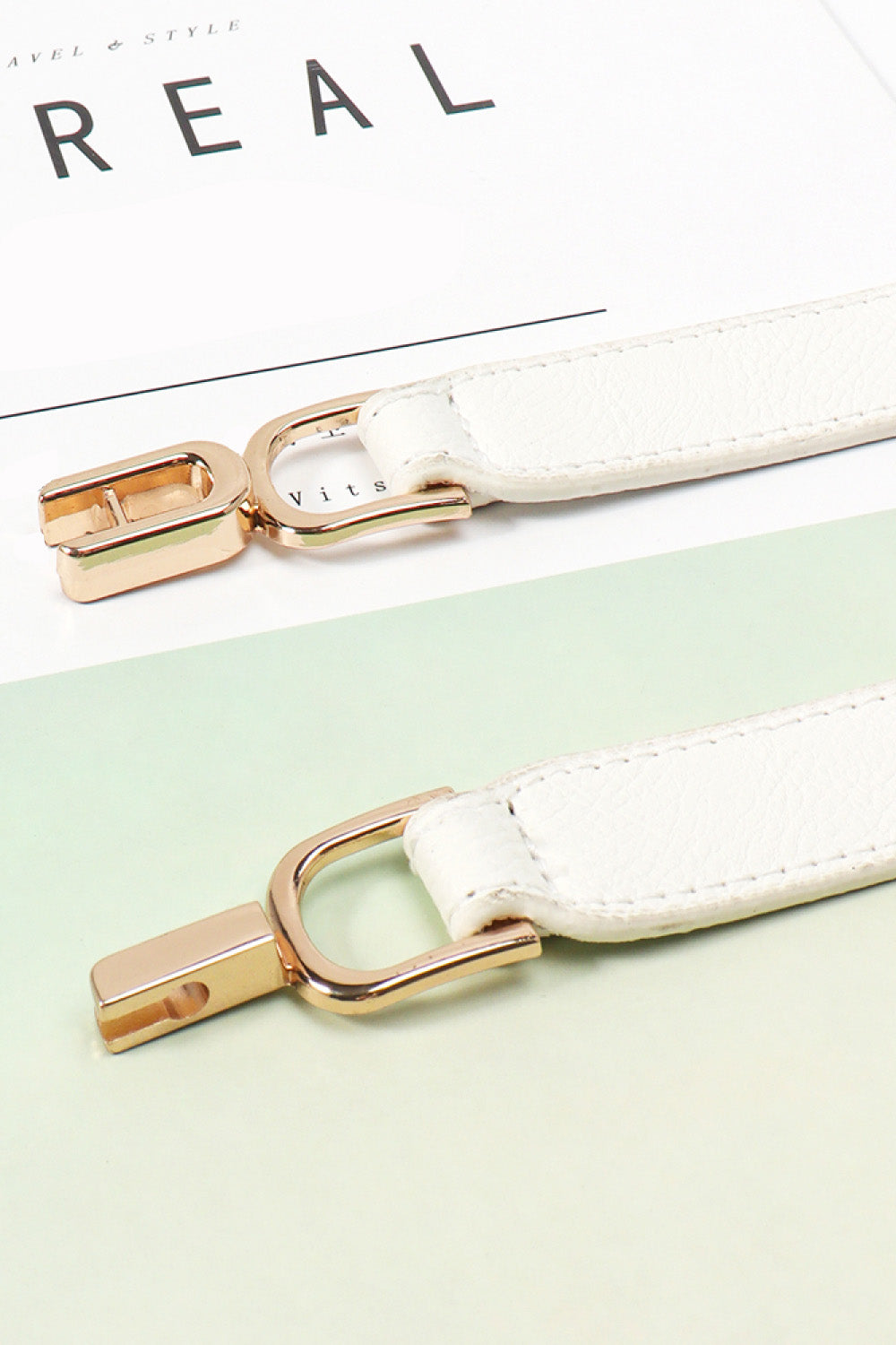White elasticated hook-clasp waist belt with gold-tone alloy hardware.