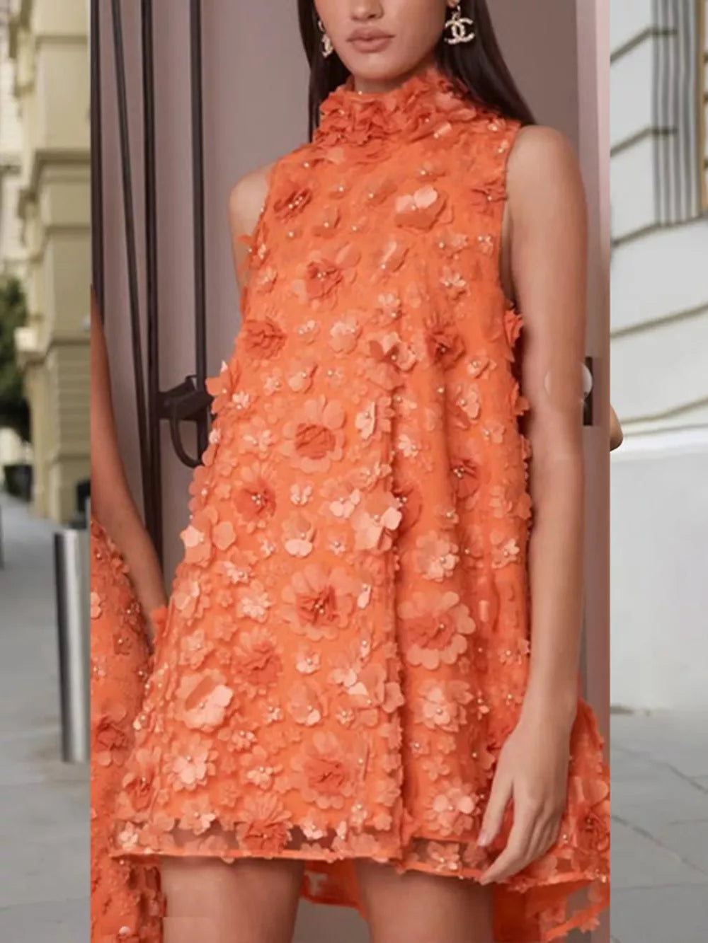 Orange ruffled floral applique mini dress with a high neckline and sleeveless design.