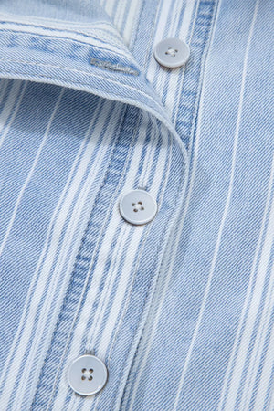 Denim shacket with blue and white vertical stripes, button-down front, and light grey buttons.