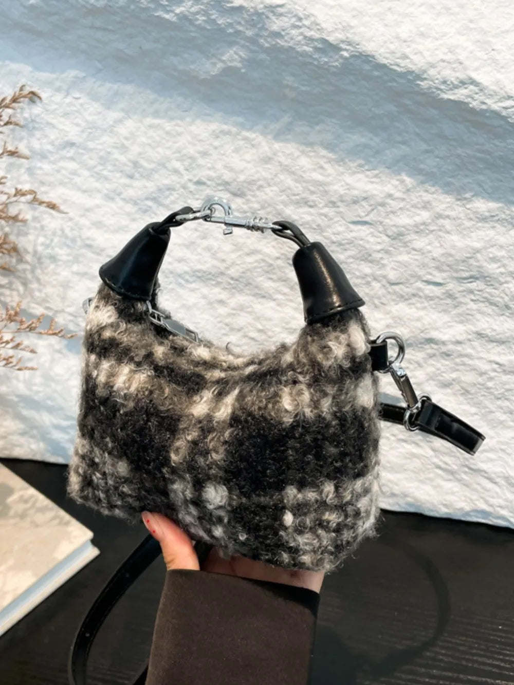 Shearling check mini shoulder bag with black and white pattern and leather details.