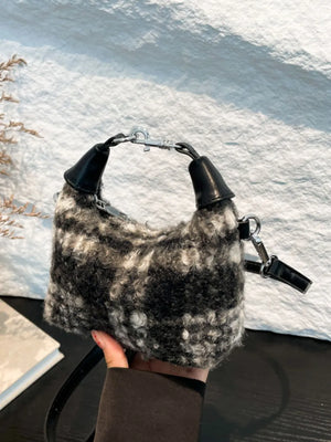 Shearling check mini shoulder bag with black and white pattern and leather details.