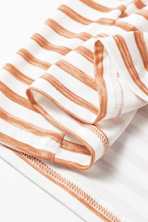 Colorblock stripe sleeveless jumpsuit in white with brown stripes, showing fabric detail.