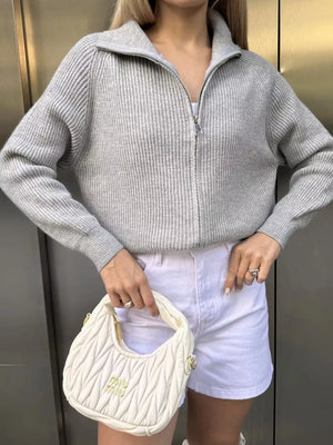 Gray ribbed knit zipper cardigan with a stand-up collar and silver zipper detail.