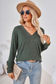 Button-cuff slouch v-neck top in dark green with long sleeves and a relaxed fit.