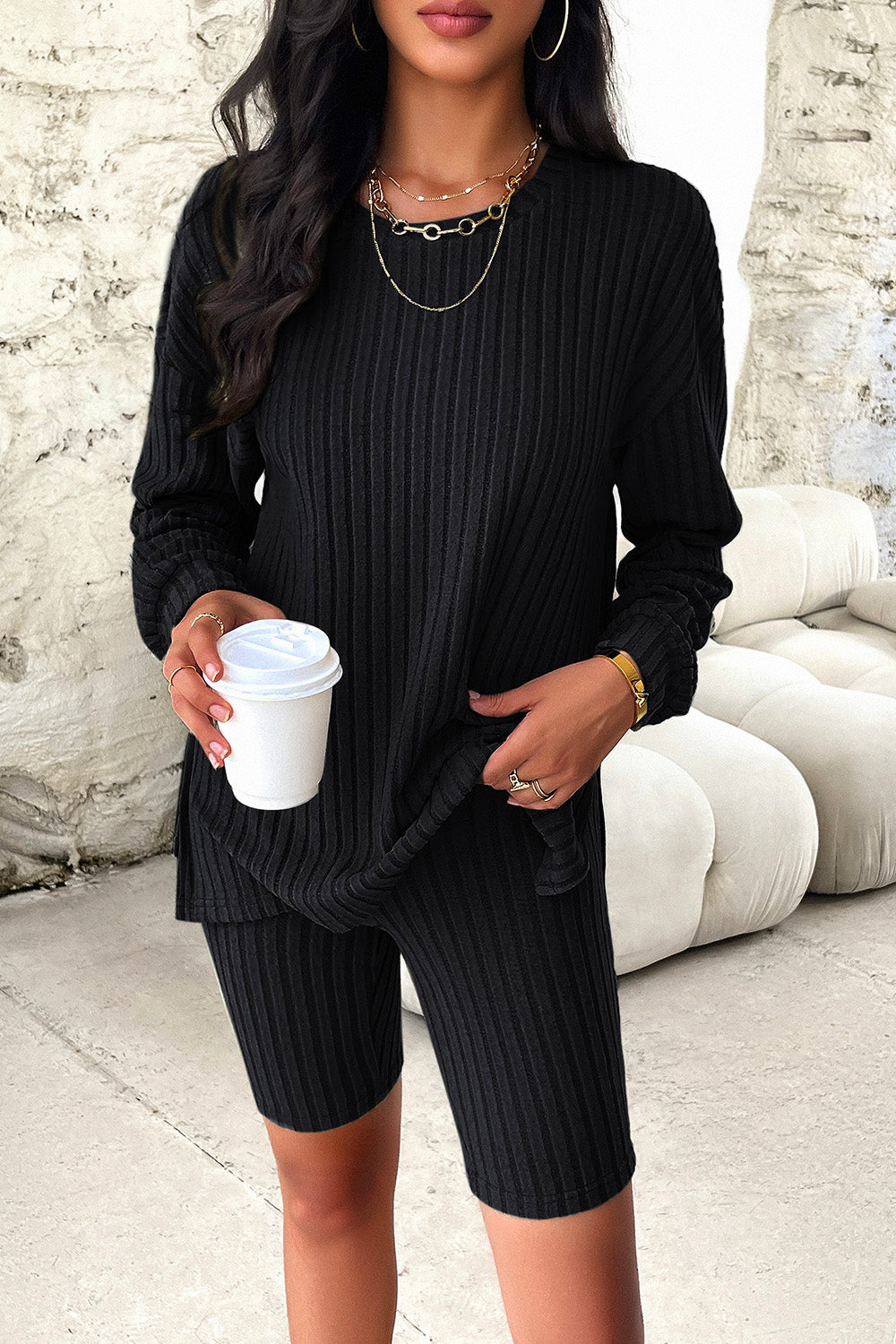 Black ribbed knit slouchy long sleeve top and bike shorts loungewear set.